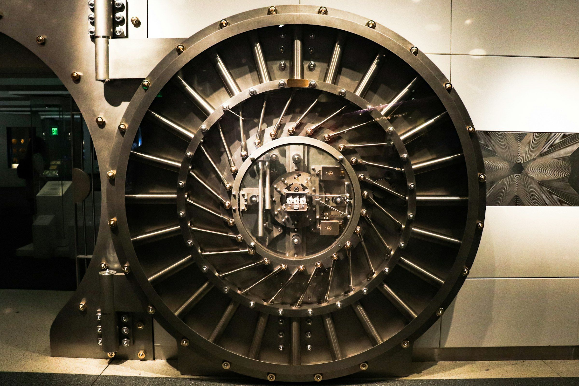 Massive circular steel vault door with radial locking bolts and an exposed lock mechanism